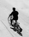 Silhouette of man cycling on a sunny day in West Bengal, India.